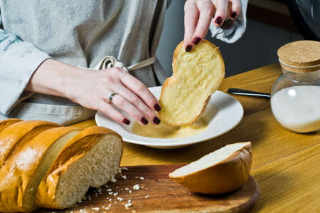 The chef cooking French toast. Black background, side view, space for text, kitchen