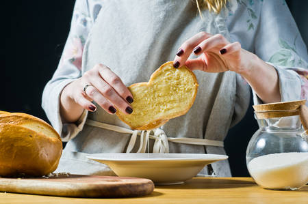 The chef cooking French toast. Black background, side view, space for text, kitchenの写真素材