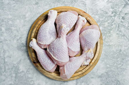 Raw chicken legs. Gray background, top view, space for text