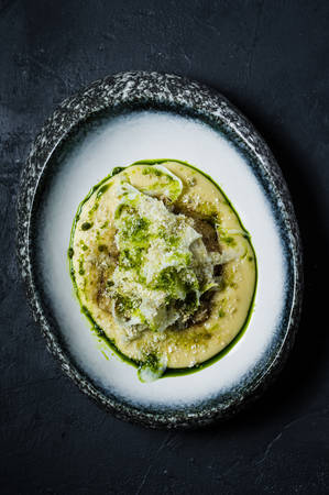 Halibut steak with celery, dark background, top view