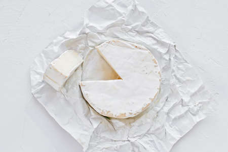 Camembert on white paper. White background, top view, close upの写真素材