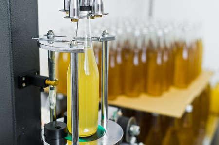 Bottling factory - Beer bottling line for processing and bottling beer into bottles.の写真素材