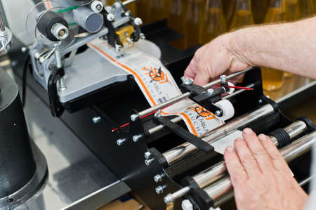 30.03.2019 Russia, St. Petersburg - Moving Bottles on Labelling machine for Industry, food industry, conveyor lineのeditorial素材