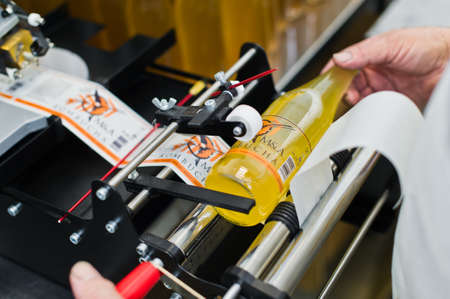 30.03.2019 Russia, St. Petersburg - Moving Bottles on Labelling machine for Industry, food industry,...
