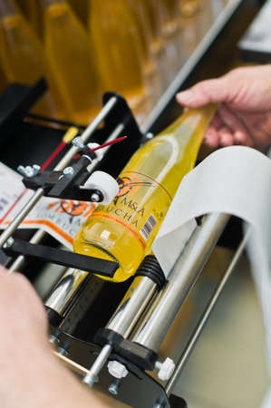 30.03.2019 Russia, St. Petersburg - Moving Bottles on Labelling machine for Industry, food industry,...