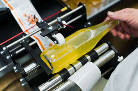 30.03.2019 Russia, St. Petersburg - Moving Bottles on Labelling machine for Industry, food industry, conveyor lineのeditorial素材