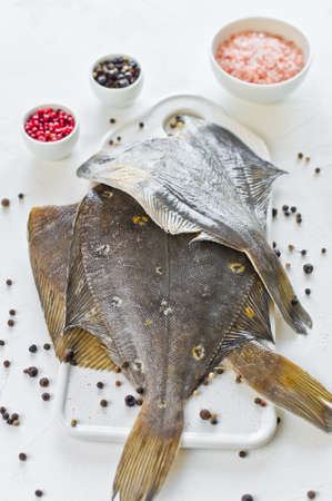 Raw plaice, ingredients for cooking. White background, top viewの写真素材