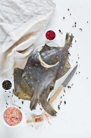Dietary healthy food - flounder, ingredients for cooking. White background, top viewの写真素材