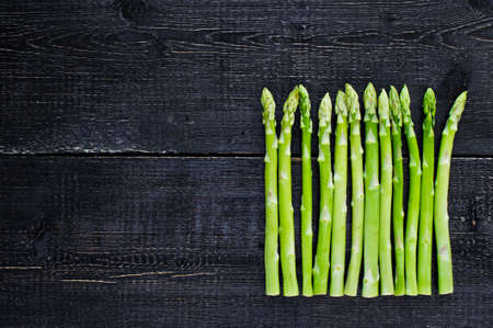 Green asparagus. Black background, top view, space for textの写真素材