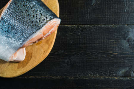 Atlantic raw salmon, steak on black wooden background.の写真素材