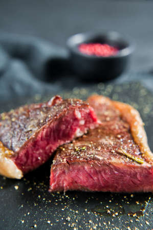 Beef rump steak roasted rare. Black background, top viewの写真素材