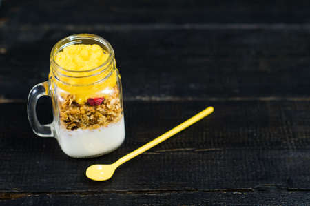 Healthy breakfast muesli and yogurt with mango smoothie in glass mason jars