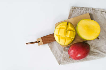 Ripe mango on the wooden cutting Board