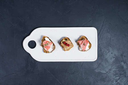 Italian antipasti with pate, Parma and salami on toast