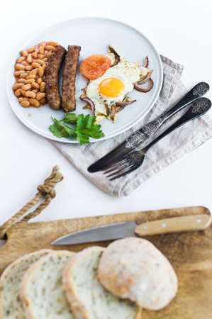 Omelet with tomatoes on a grey plate on a white backgroundの写真素材