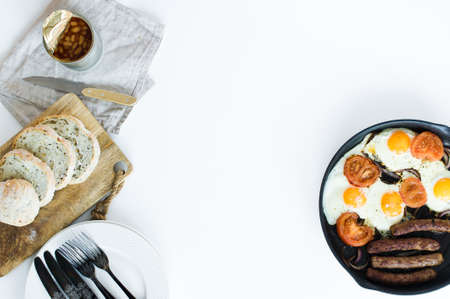 Omelet with tomatoes in a pan on a white background