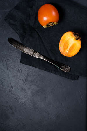 Persimmon on black fabric with space for textの写真素材