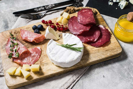 Italian antipasto with prosciutto, salami, Parmesan cheese, brie and Gorgonzola, honeyの写真素材