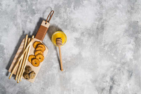 set of crackers on wooden chopping Board, honeyの写真素材