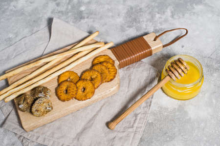 set of crackers on wooden chopping Board, honeyの写真素材