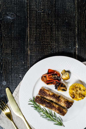 beef shish kebab with garnish of champignons, bell peppers and corn.の写真素材