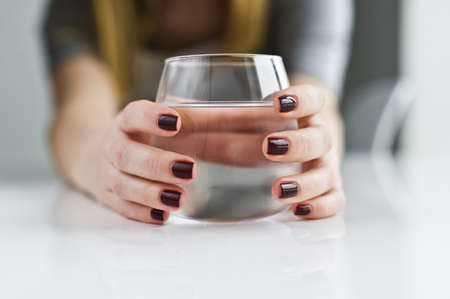 hands holding a glass of clean waterの写真素材