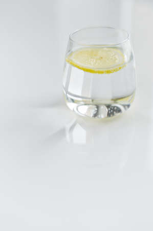 glass of clear water with lemonの写真素材