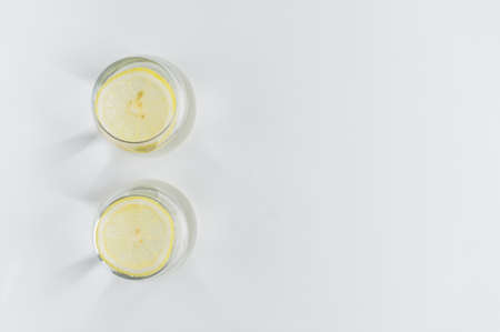 two glasses of pure water with lemonの写真素材
