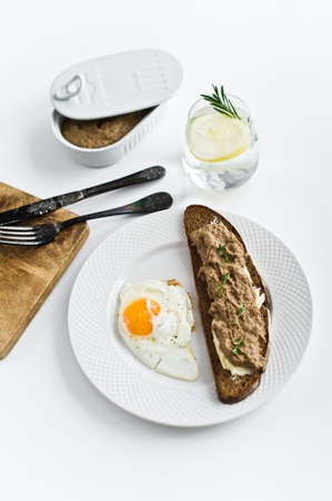 fried egg, liver pate on bread .の写真素材