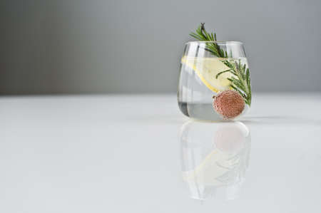 glass of clear water with lemon, rosemary, lycheeの写真素材