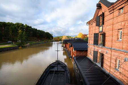 Classic old wood red houses and their reflection in river. Porvoo, Finland.の写真素材