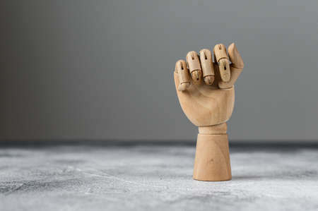 The wooden hand is clenched into a fist. The concept of communicationの写真素材