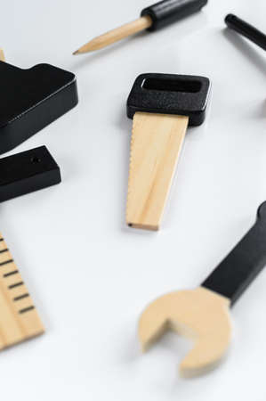 Children wooden tools on a white background, saw hexagon in the center of the composition. The concept of diy.の写真素材