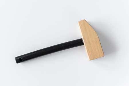 Children wooden toy hammer on a white background.