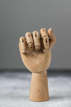 The wooden hand is clenched into a fist. The concept of communicationの写真素材