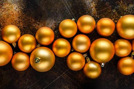 Christmas Flat Lay, new year background. Gold baubles on Dark Background. Selective focus. Minimalistic design.の写真素材