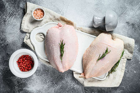 Raw chicken Breasts, fresh fillets with skin. Organic farm bird. Gray background.の写真素材