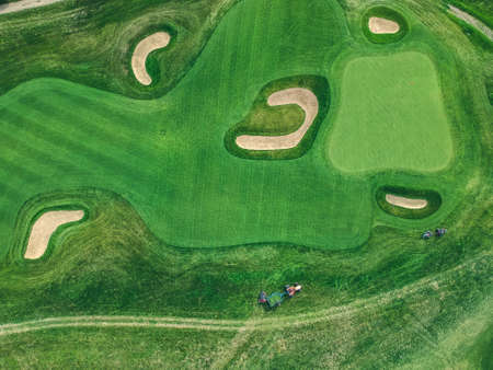 Aerial photo of Golf club, green lawns, trees, road, lawn mowers, Flatley.の写真素材
