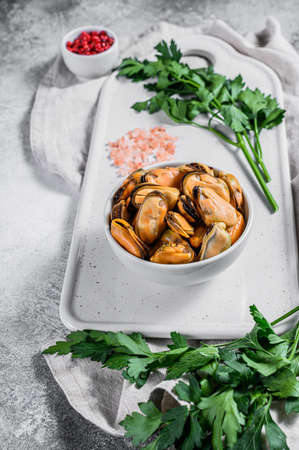 Fresh raw mussel on a chopping Board. Healthy seafood. Light background.の写真素材