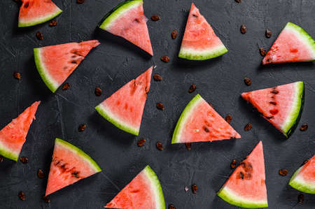 Watermelon pattern. Red watermelon on dark background. Summer concept. Flat lay, top view.