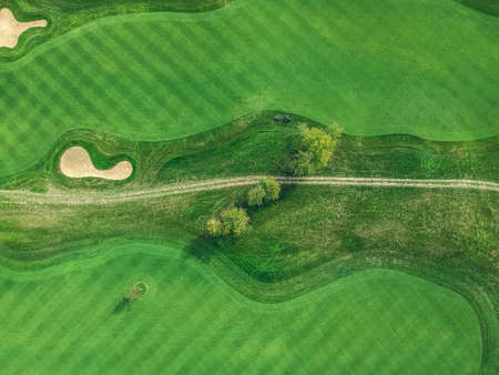 Aerial photo of Golf club, green lawns, trees, road, lawn mowers, Flatley.の写真素材