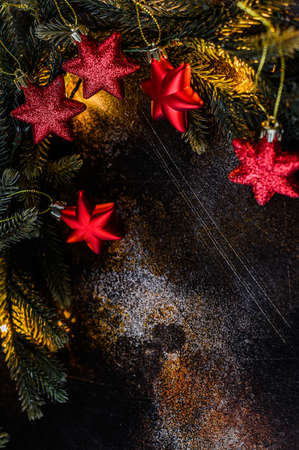 Happy New Year 2020. Christmas background with xmas tree, red stars and glowing golden bokeh lights...