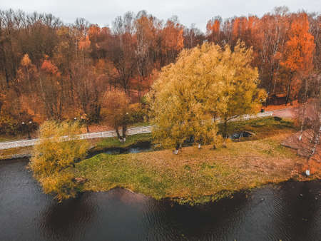 Aerial view walking path along the lake, colorful autumn forest. St. Petersburg, Russiaの写真素材