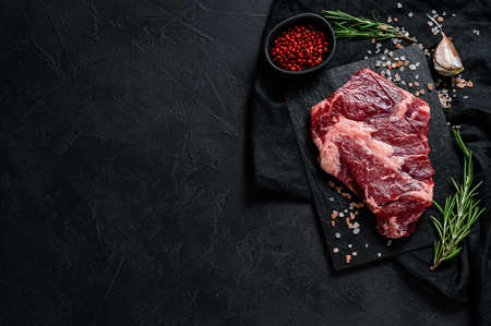 Raw black Angus steak. Organic farm beef black Angus. Black background. Space for text.