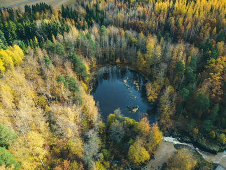 Aerial view of a beautiful lake in the middle of the forest. Photo taken from a drone. Finland,...