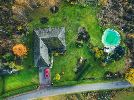 Aerial view of a country house in the woods, the trees and the road. Photo taken from a drone. Finland, Pornainenの写真素材