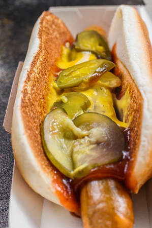 Hot dog with beef sausage in a cardboard box, food delivery concept. Junk food. Close upの写真素材