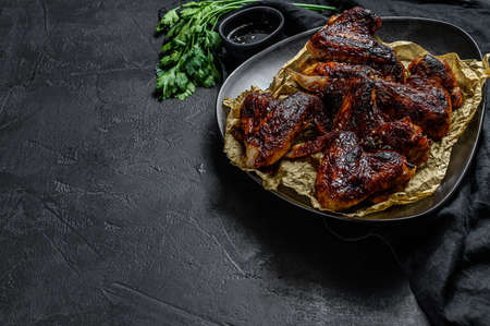Barbecue chicken wings. Farm organic poultry. Top view. Black background. Space for textの写真素材