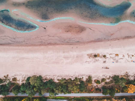 Aerialphoto of the Baltic sea beach. Azure waves, sand ridges, footprints in the sand