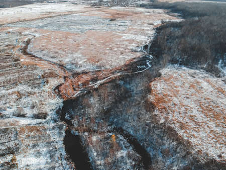 Aerial view of the forest and river at winter. Trees are covered with snow. Winter. snow-covered...